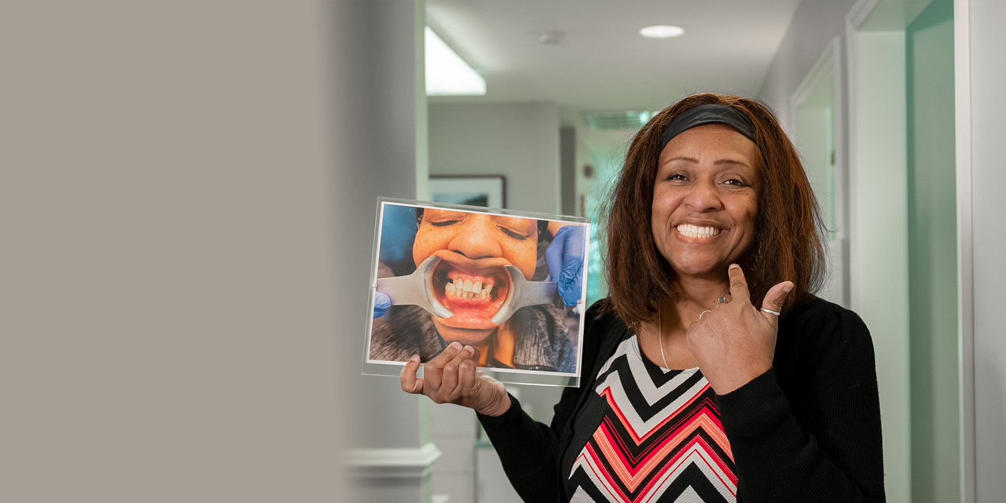 patient holding up a before and after photo